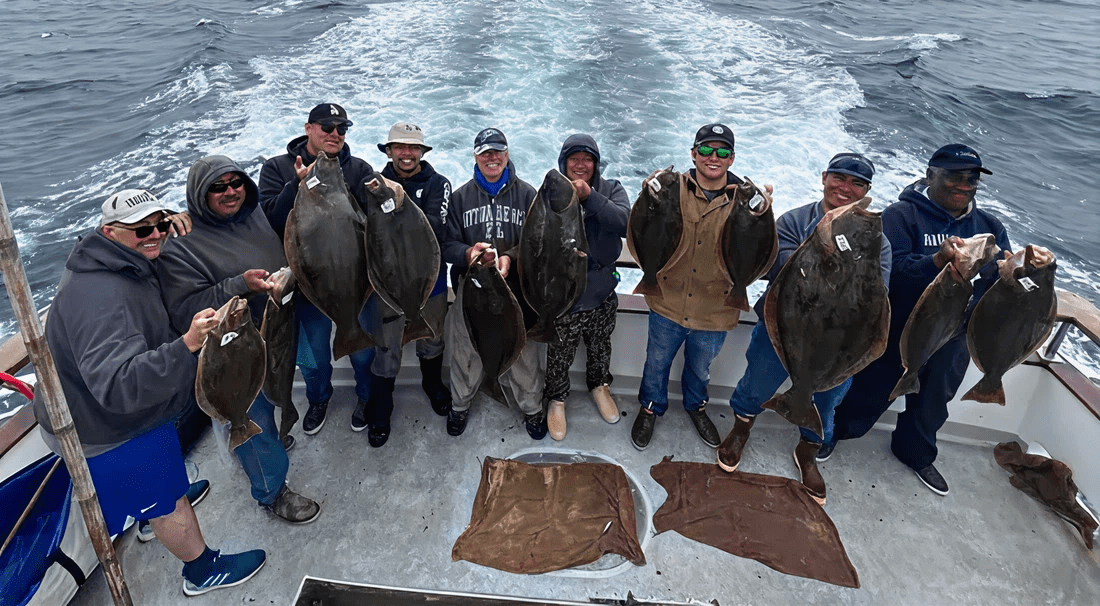 Group holding large fish on boat