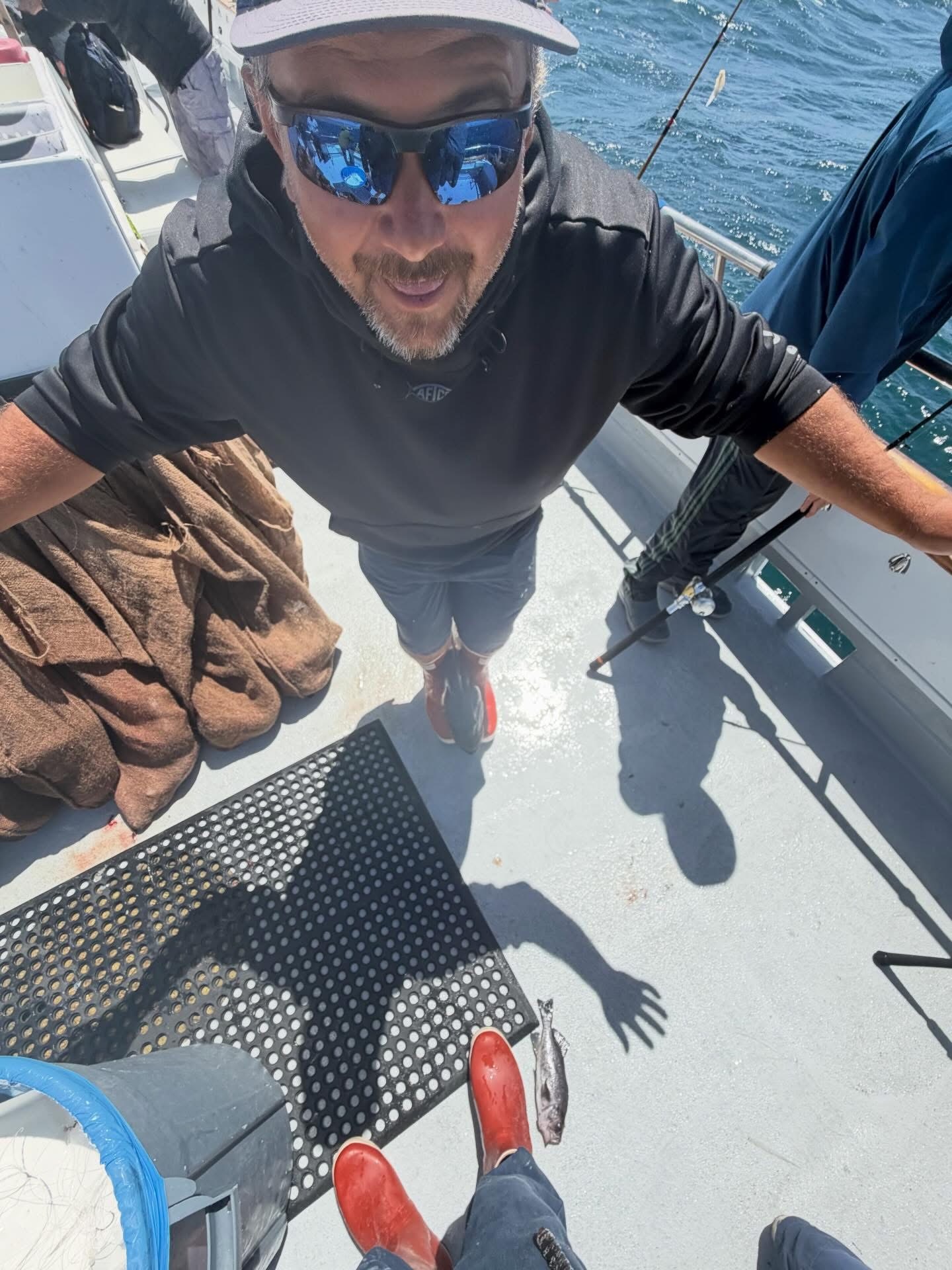 Man in sunglasses on fishing boat deck
