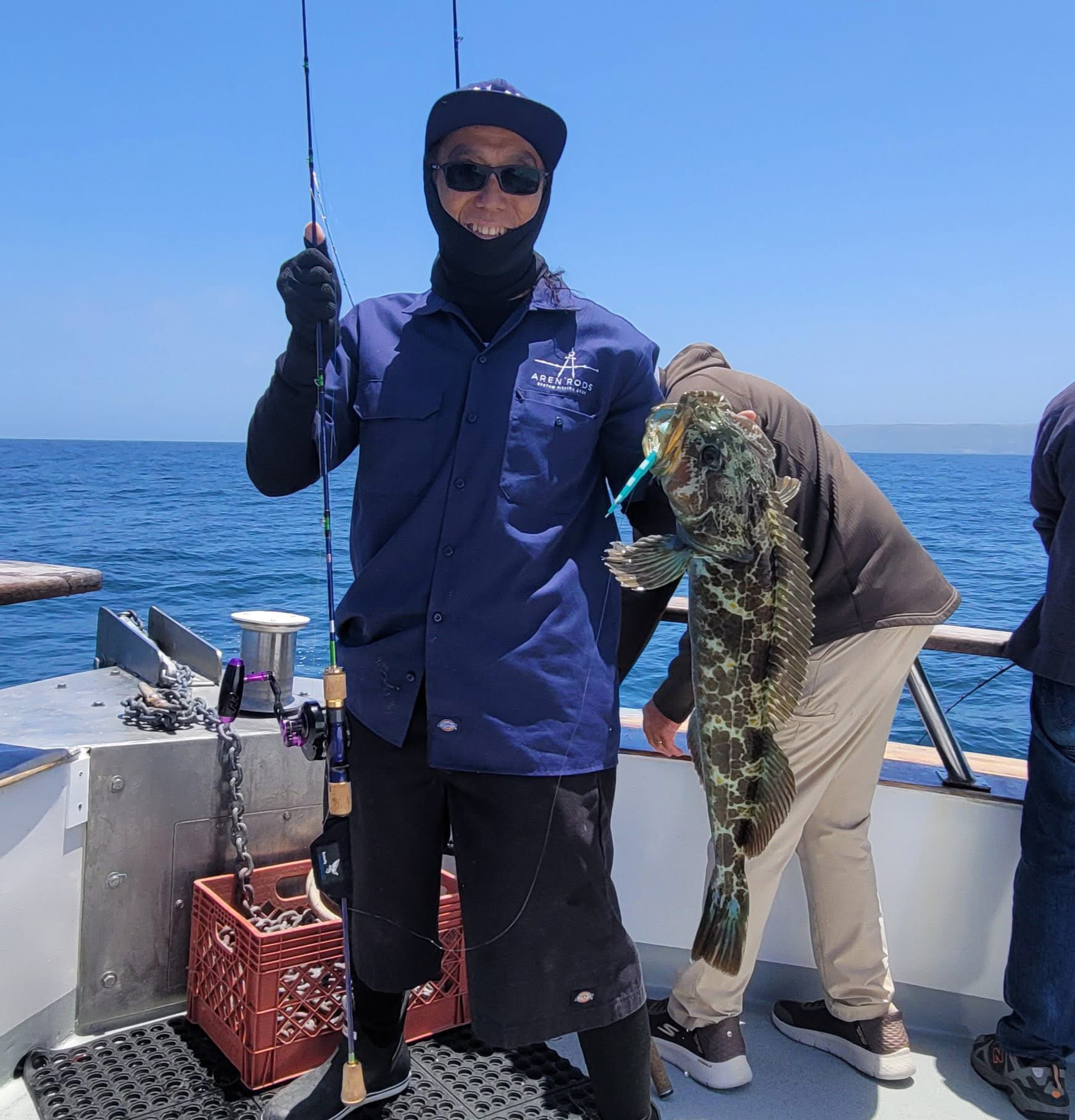 Person holding large fish on fishing boat