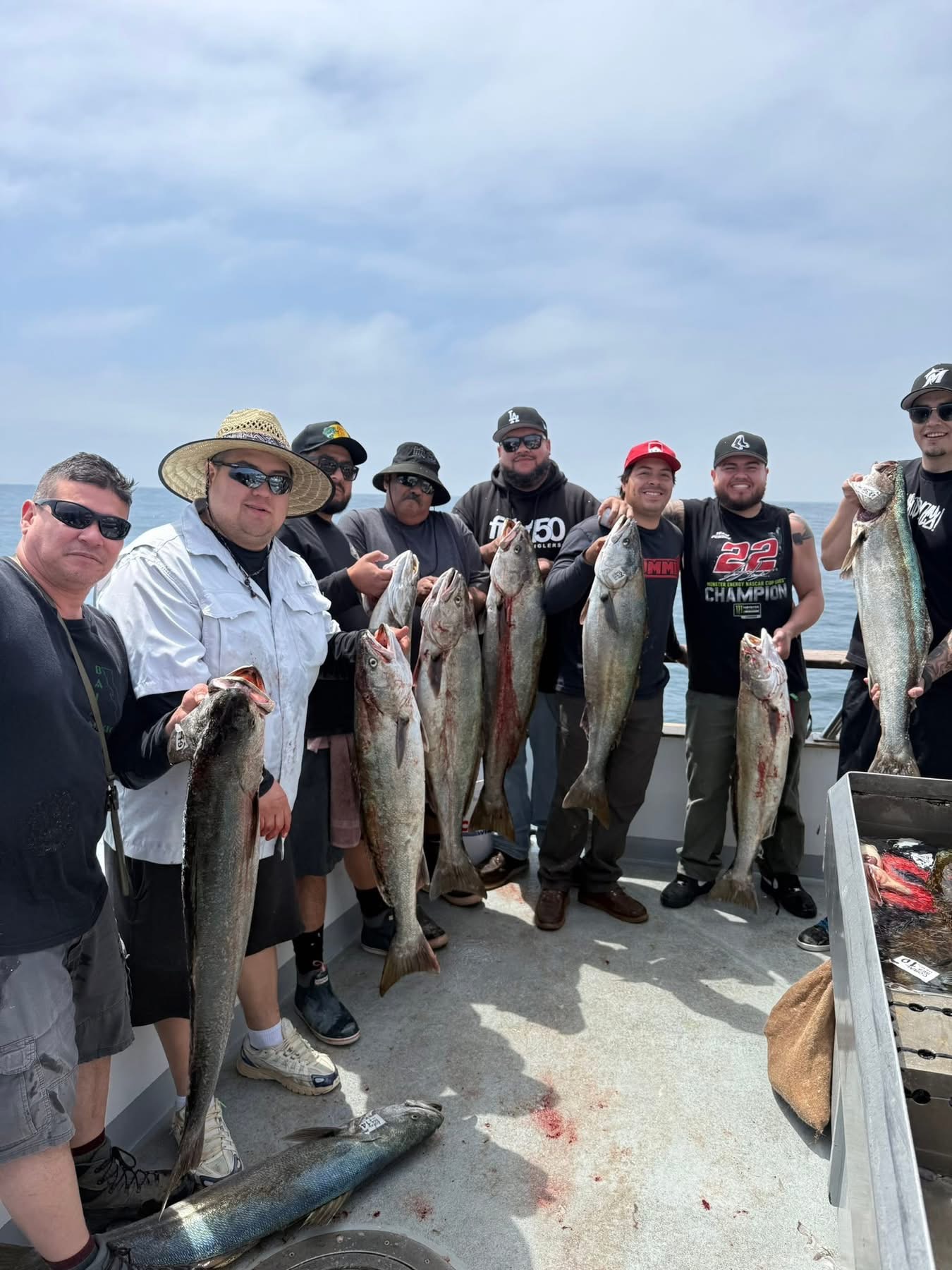 Fishermen holding freshly caught large fish