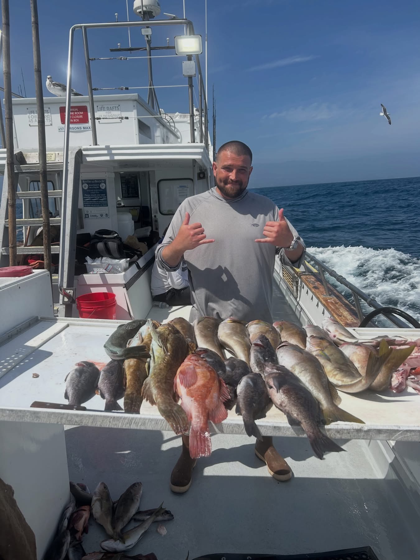 Fisherman posing with large catch on boat