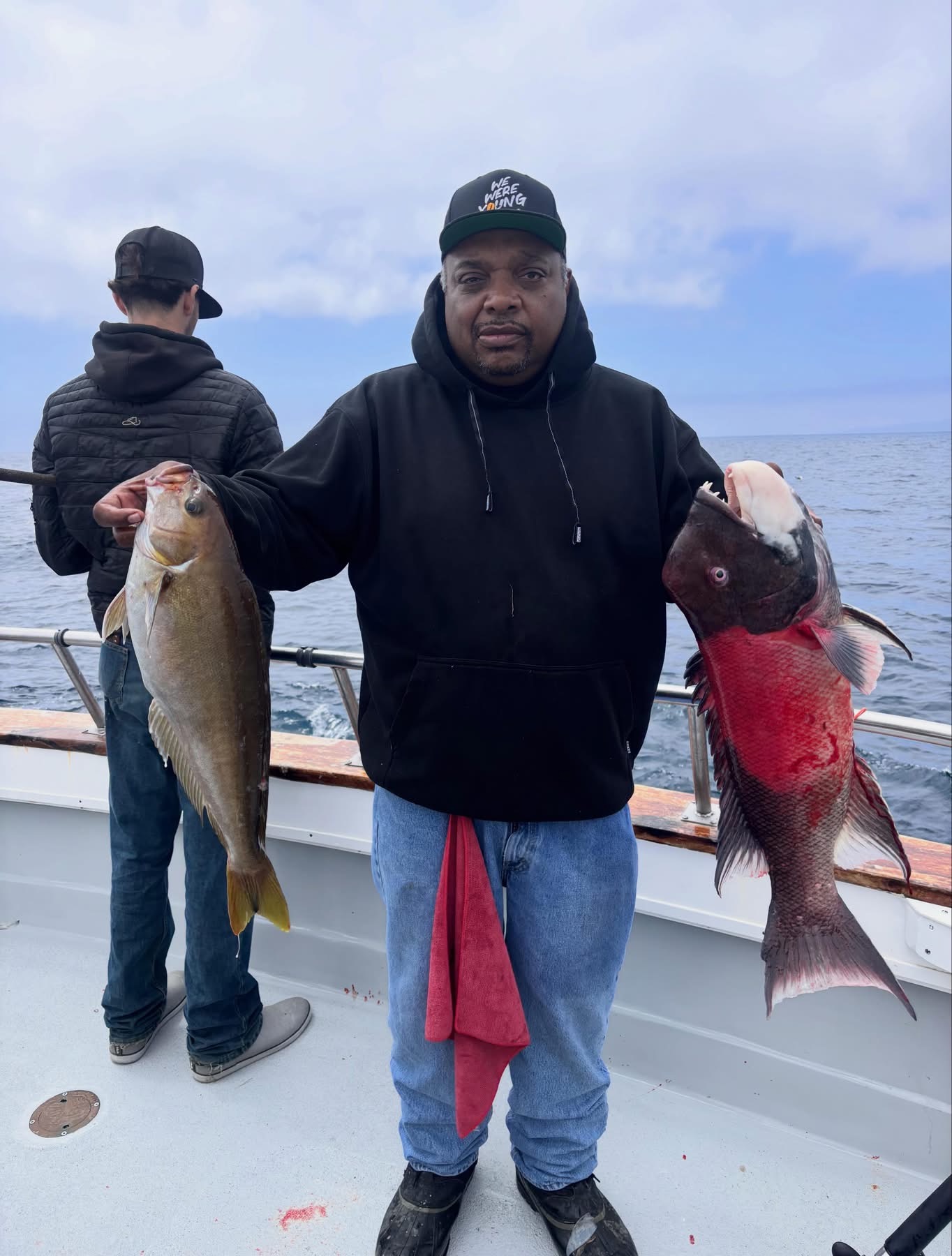 Fisherman holding two large caught fish